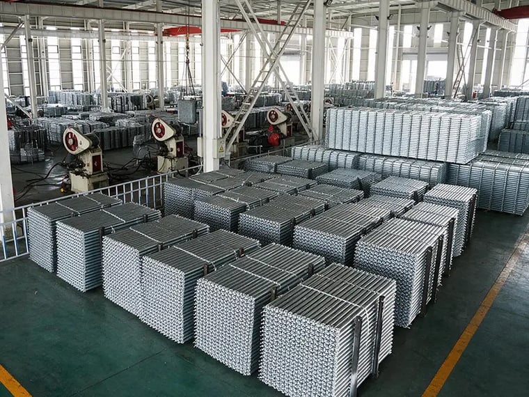 Stacks of galvanized ringlock scaffolding steel planks in the LuckyScaffolding factory